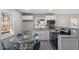 Eat-in kitchen features stainless steel appliances, granite countertops, and light gray subway tile at 838 Waring St, Durham, NC 27704