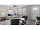 Cozy living room with neutral walls and hardwood flooring offers ample natural light and ceiling fan at 838 Waring St, Durham, NC 27704