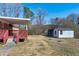 Backyard showcasing a deck, a storage shed, and a spacious outdoor area at 8604 N Roxboro St, Bahama, NC 27503
