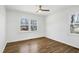 This bedroom features hardwood-style floors and large windows at 8604 N Roxboro St, Bahama, NC 27503