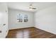 Light-filled bedroom with new wood-look flooring and a bright window at 8604 N Roxboro St, Bahama, NC 27503