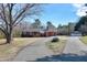 Charming brick home with a well-maintained lawn, a long driveway, and a detached garage at 8604 N Roxboro St, Bahama, NC 27503