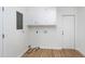 Practical laundry room with white cabinets and access to the exterior at 8604 N Roxboro St, Bahama, NC 27503
