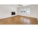Well-lit living room with luxury floors, a built in electric fireplace and large window providing serene views at 8604 N Roxboro St, Bahama, NC 27503