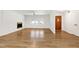 Spacious living room boasting beautiful floors, a fireplace, ceiling fan and lots of light from large front window at 8604 N Roxboro St, Bahama, NC 27503
