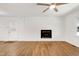 Bright living room featuring wood floors, fireplace, and ceiling fan at 8604 N Roxboro St, Bahama, NC 27503