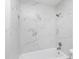 White shower with white marble-like tile and a shower head at 8604 N Roxboro St, Bahama, NC 27503