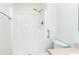 The bathroom shower features white tile and a showerhead with assistance bar at 8604 N Roxboro St, Bahama, NC 27503