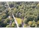 Aerial view of a home nestled among lush trees, showcasing its expansive yard and neighborhood at 938 Hargrove St, Henderson, NC 27536