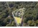 Aerial view of property showing the mature trees and landscaping and lot outline at 938 Hargrove St, Henderson, NC 27536