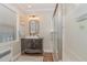 Traditional bathroom featuring a modern vanity, sleek glass shower door, and wood look floors at 938 Hargrove St, Henderson, NC 27536