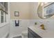 Bathroom featuring white tile, modern fixtures, and a dark vanity at 938 Hargrove St, Henderson, NC 27536