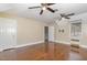 Large bedroom featuring hardwood floors, two windows, and two ceiling fans at 938 Hargrove St, Henderson, NC 27536