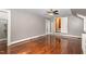 This bedroom features hardwood floors, a ceiling fan and natural light through a window at 938 Hargrove St, Henderson, NC 27536