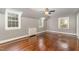 This bedroom has hardwood floors, three windows providing natural light and a ceiling fan at 938 Hargrove St, Henderson, NC 27536