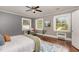 Stylish bedroom featuring three large windows allowing for ample natural light and hardwood flooring at 938 Hargrove St, Henderson, NC 27536