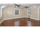 Spacious bedroom featuring beautiful hardwood floors, two ceiling fans, and two windows at 938 Hargrove St, Henderson, NC 27536