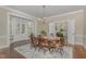 Dining room with hardwood floors, natural light, an elegant chandelier, and a table with seating for six at 938 Hargrove St, Henderson, NC 27536