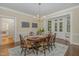 Dining room with hardwood floors, natural light, an elegant chandelier, and a table with seating for six at 938 Hargrove St, Henderson, NC 27536