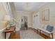 Inviting foyer with hardwood floors, decorative wallpaper, a staircase, and a seating area at 938 Hargrove St, Henderson, NC 27536