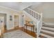 Elegant foyer featuring hardwood floors, decorative wallpaper, staircase and traditional architectural details at 938 Hargrove St, Henderson, NC 27536