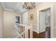 Upstairs hallway with hardwood floors and access to multiple bedrooms at 938 Hargrove St, Henderson, NC 27536