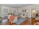 Spacious living room with hardwood floors, a sofa, chairs and a glimpse of the dining room at 938 Hargrove St, Henderson, NC 27536