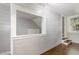 This living room has white painted walls, hardwood floors, stairs and a window that looks into another room at 938 Hargrove St, Henderson, NC 27536