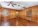 This living room features warm wood paneling, hardwood floors and natural light from two windows at 938 Hargrove St, Henderson, NC 27536