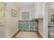 Butler's pantry with a butcher block counter, upper and lower cabinets, and hardwood floors at 938 Hargrove St, Henderson, NC 27536