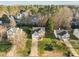 Aerial view of the home showing the front yard, roof and proximity to other homes and trees at 1006 Scotsburg Trl, Hillsborough, NC 27278