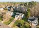 An eye-level view of several homes with green lawns, bare trees, and lush green conifers at 1006 Scotsburg Trl, Hillsborough, NC 27278