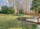 Landscaped backyard featuring a wooden fence, grass, and a variety of plants at 1006 Scotsburg Trl, Hillsborough, NC 27278