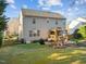 View of the home's backyard featuring a well-maintained lawn, deck with a gazebo, and patio area at 1006 Scotsburg Trl, Hillsborough, NC 27278