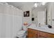 Clean bathroom with a shower, toilet, and wood-finish vanity at 1006 Scotsburg Trl, Hillsborough, NC 27278