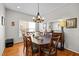 Charming dining room with hardwood floors and ample natural light, perfect for Gathering gatherings and entertaining guests at 1006 Scotsburg Trl, Hillsborough, NC 27278