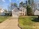Attractive two-story home with a long driveway and large lawn, offering ample space and curb appeal in a suburban setting at 1006 Scotsburg Trl, Hillsborough, NC 27278