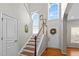 Bright foyer with hardwood floors, complemented by an entry door with wreath, and natural light streaming through arched windows at 1006 Scotsburg Trl, Hillsborough, NC 27278