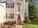 Inviting front entrance with decorative shutters and a well-manicured garden, creating a warm and welcoming curb appeal at 1006 Scotsburg Trl, Hillsborough, NC 27278
