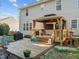 View of the back deck and gazebo, with comfortable seating and a mounted television at 1006 Scotsburg Trl, Hillsborough, NC 27278