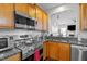 Galley-style kitchen with stainless appliances, granite counters, and backsplash overlooks living space at 1006 Scotsburg Trl, Hillsborough, NC 27278