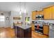 Open eat-in kitchen has stainless appliances, granite countertops, a center island and hardwood floors at 1006 Scotsburg Trl, Hillsborough, NC 27278
