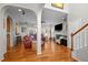 Spacious open-concept living room with hardwood floors, a fireplace, and an adjacent dining area for seamless entertaining at 1006 Scotsburg Trl, Hillsborough, NC 27278
