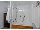 Tile shower featuring a glass shower door, wooden trim, and shower head at 1006 Scotsburg Trl, Hillsborough, NC 27278