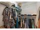 Walk-in closet with metal shelving and multiple clothes hanging from the rods at 1006 Scotsburg Trl, Hillsborough, NC 27278