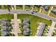An aerial view of several townhomes featuring green lawns, trees, and convenient parking at 101 Wimbledon Ct, Clayton, NC 27520