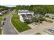 Aerial view of townhomes showcasing well-maintained lawns, ample parking, and mature trees at 101 Wimbledon Ct, Clayton, NC 27520