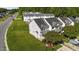Aerial view of a townhome with a well-kept lawn and proximity to lush green space at 101 Wimbledon Ct, Clayton, NC 27520