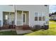View of back porch area, showing access to the home and compact outdoor space at 101 Wimbledon Ct, Clayton, NC 27520