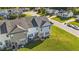 Aerial shot of a townhome backyard with lawn and a glimpse of a surrounding neighborhood at 101 Wimbledon Ct, Clayton, NC 27520